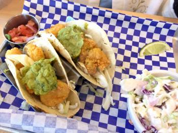 Fresh fried shrimp tacos on blue white checkerboard paper