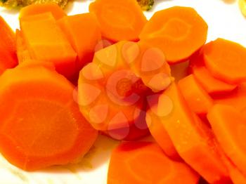carrots cooked and sliced on plate with vibrant orange
