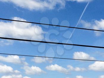 blue sky white clounds with power lines on sunny day jet streams