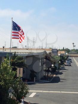 Trailer park mobile homes america flag with clean street sunny day