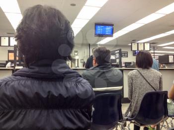 Department of motor vehicles DMV California America people waiting in crowded line indoor government office