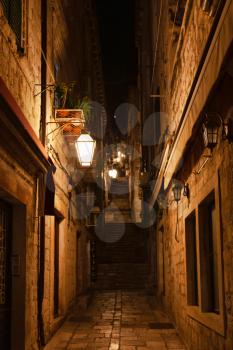 Dubrovnik, Croatia - 21 February 2019: Narrow medieval street by night