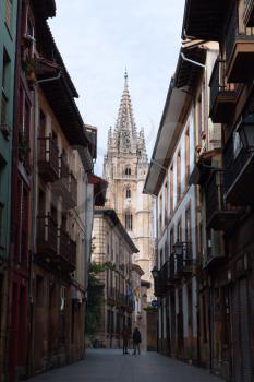 Oviedo, Spain - 11 December 2018: Streets of Oviedo and The Metropolitan Cathedral Basilica of the Holy Saviour or Cathedral of San Salvador in the baclground