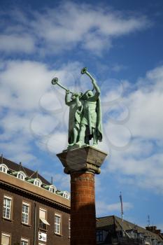 Statue of two trumpeters Vikings blow into a tube, which is called Lure near city town hall in Copenhagen, Denmark.

