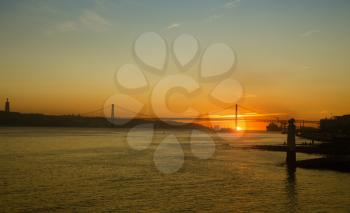 View of The 25 de Abril Bridge in Lisbon, Portugal during sunset