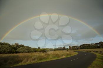 Full rainbow over an australian landscape at Philip island in Australia