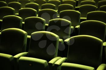 Side view of a green velvet seat in a theatre or a cinema