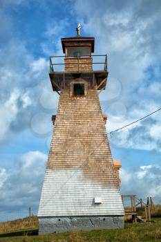 Old Cape Tryon lighthouse with a nice blue sky with clouds in Prince Edward island in Canada 