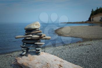 Inukuk standing on a rock in gaspesie, Quebec. An inuksuk is a human-made stone landmark.