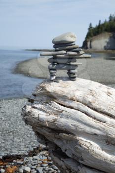 Inukuk standing on a rock in gaspesie, Quebec. An inuksuk is a human-made stone landmark.