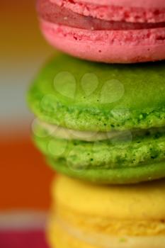 Pile of tasty macaroons on colourful background