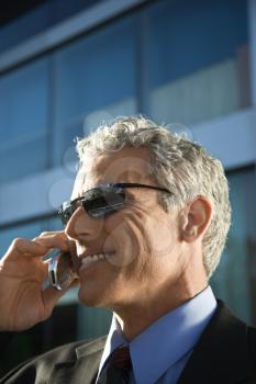 Royalty Free Photo of a Businessman Talking on a Cellphone in an Urban Setting