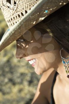 Royalty Free Photo of a Woman Wearing a Cowboy Hat and Smiling