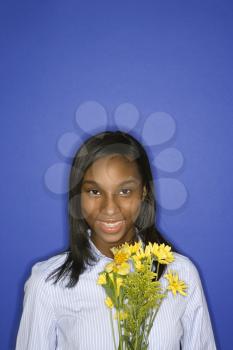 Royalty Free Photo of a Smiling Teenage Girl Holding a Bouquet
