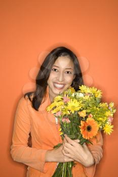 Royalty Free Photo of a Smiling Teen Girl Holding a Bouquet of Flowers 