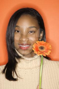 Royalty Free Photo of a Teen Girl Holding a Daisy