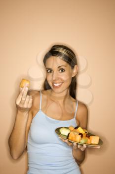 Royalty Free Photo of a Woman Holding a Plate of Fruit