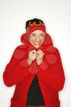 Royalty Free Photo of an Older Woman Wearing a Coat and Flame Hat
