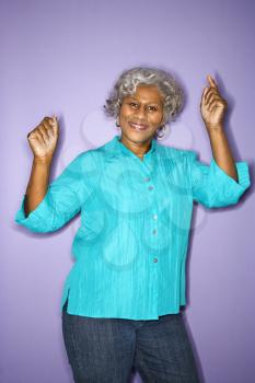 Royalty Free Photo of an Older Woman Smiling and Dancing