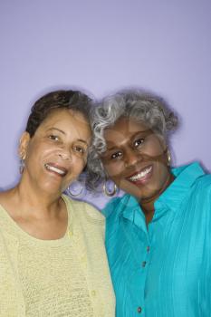 Mature adult African American females smiling looking at viewer.