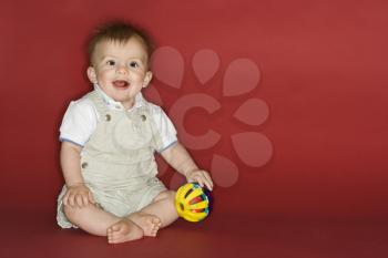 Royalty Free Photo of a Little Boy Playing With a Ball