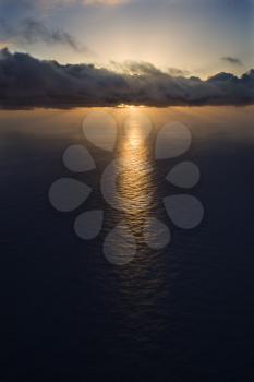 Royalty Free Photo of an Aerial of a Sun Setting Over the Pacific Ocean with Clouds