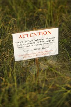 Royalty Free Photo of a Beach Sign Warning to Stay Off Dunes