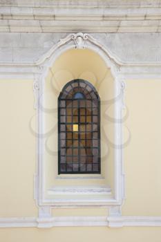 Recessed window with colored panes in building in Lisbon, Portugal.