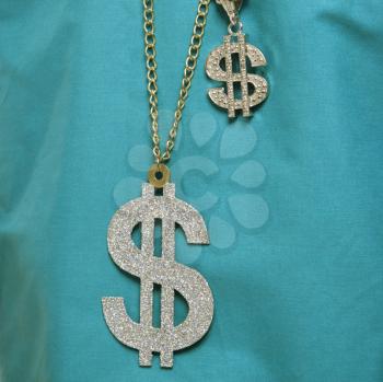 Royalty Free Photo of a Close-up of Medical Scrubs With Two Dollar Sign Necklaces