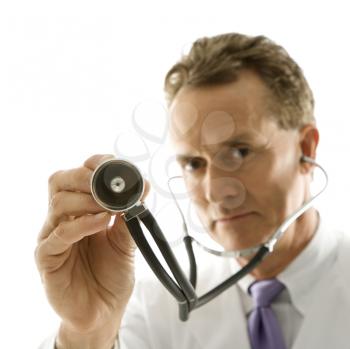 Royalty Free Photo of a Doctor Holding Out a Stethoscope