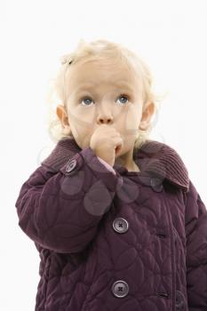 Royalty Free Photo of a Toddler Girl Sucking Her Thumg