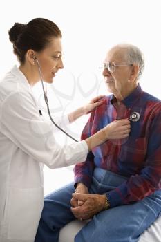 Royalty Free Photo of a Doctor Listening to a Man's Heart With a Stethoscope 