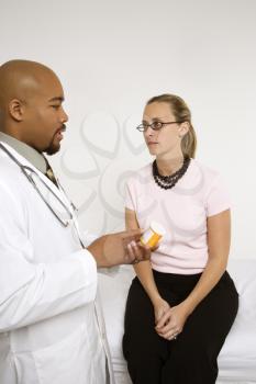 Royalty Free Photo of a Doctor Explaining Medication to a Female Patient