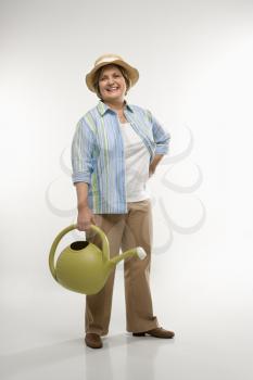 Royalty Free Photo of a Woman Holding a Watering Can