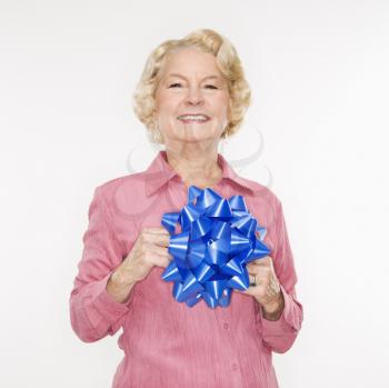 Royalty Free Photo of an Older Woman Holding a Blue Bow