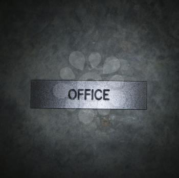 Royalty Free Photo of a Metal Office Sign