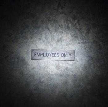 Royalty Free Photo of a Metal Employees Only Sign on a Textured Background