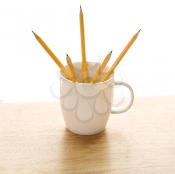 Royalty Free Photo of Five Pencils in a Coffee Mug With Pointed Ends Up