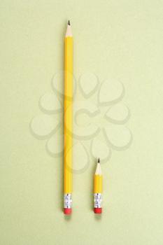 Royalty Free Photo of a Long Pencil and a Short Pencil Placed Side by Side in Comparison