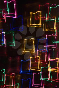 Multicolored lights forming abstract square pattern from motion blur.