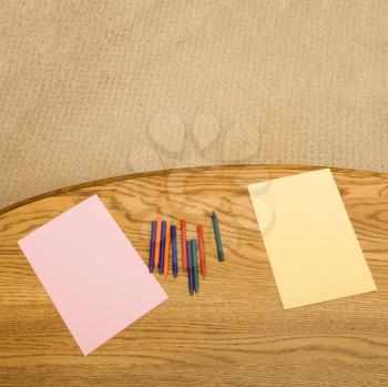 Royalty Free Photo of Construction Paper and Crayons on a Table