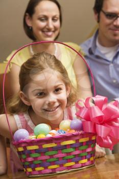 Royalty Free Photo of a Family With a Girl and an Easter Basket.