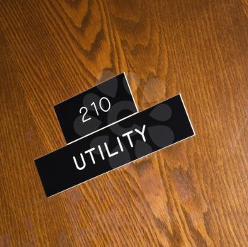 Royalty Free Photo of a Utility Sign on a Wooden Door