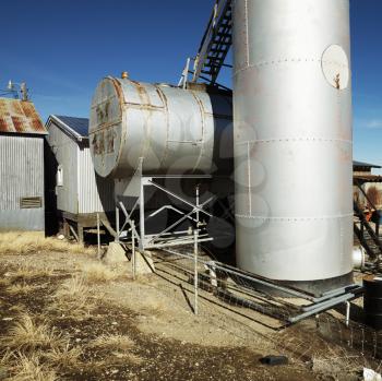 Rural landscape with metal tanks.