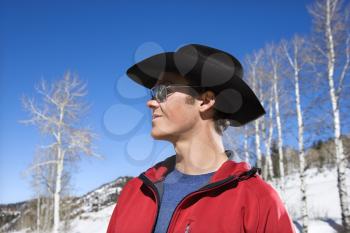 Royalty Free Photo of Young Cowboy Wearing Sunglasses and Cowboy Hat in Winter