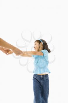 Royalty Free Photo of an Asian Girl Playing and Holding Hands with Father