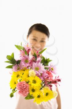 Royalty Free Photo of a Woman Holding a Bouquet of Flowers