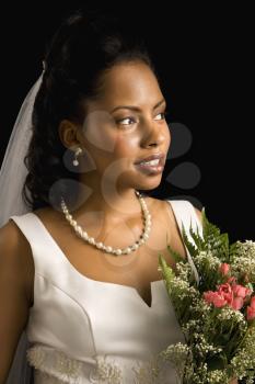 Portrait of a mid-adult African-American bride on black background.