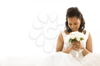 Royalty Free Photo of a Bride Holding a Bouquet of Flowers