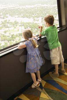 Caucasian young children looking out observation deck at Tower of the Americas in San Antonio, Texas.